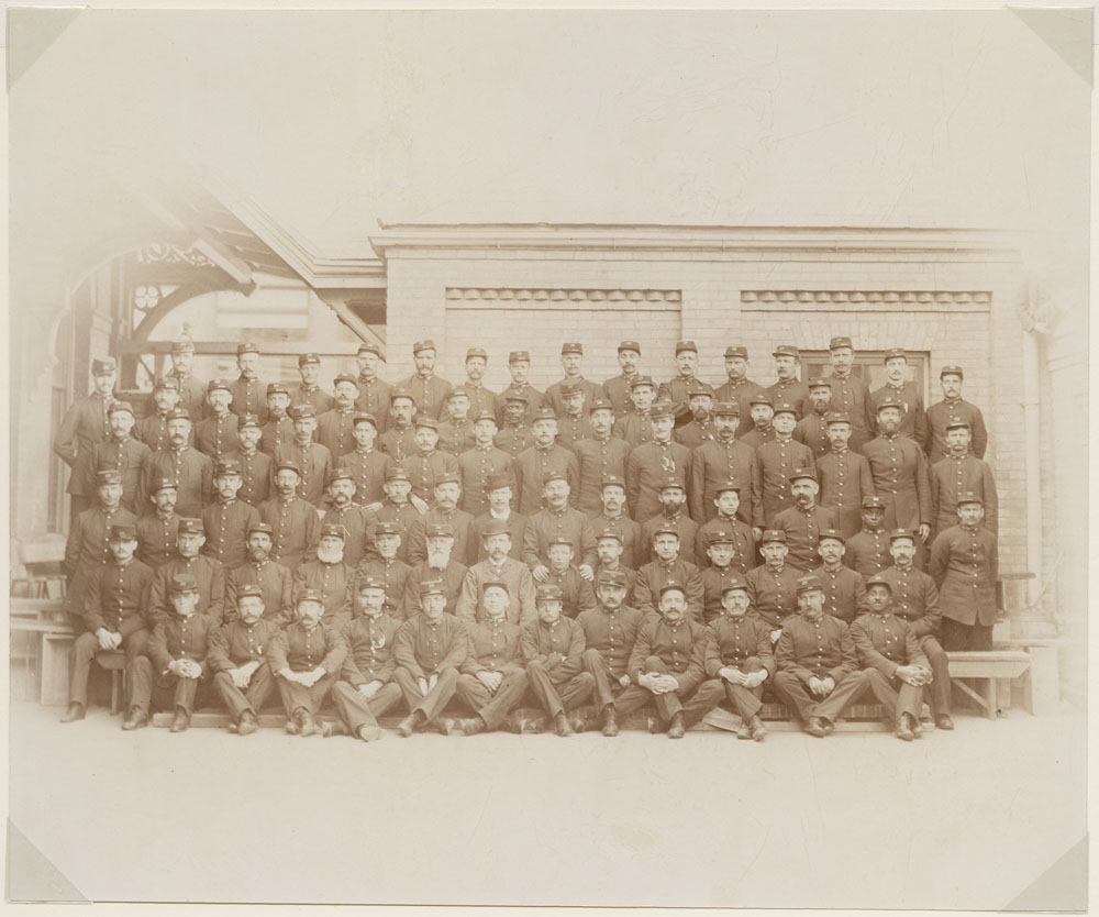 Sepia group photograph of Toronto letter carriers in uniform, late nineteenth century
